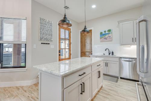 a kitchen with white cabinets and a refrigerator at Northlake Vacation Rental with Pool and Hot Tub Access in Northlake