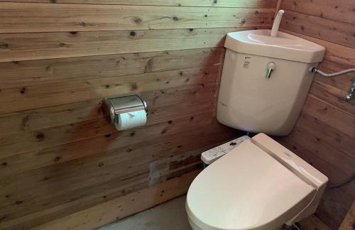 a bathroom with a white toilet in a wooden wall at Yato Furusato Forest - Vacation STAY 21069v 