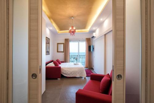 a living room with a red couch and a bed at Appartement in Naxos - b58780 in Giardini Naxos