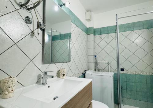 a bathroom with a sink and a toilet and a mirror at MareVivo Marzamemi in Marzamemi