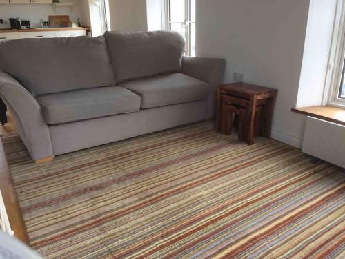 a living room with a couch and a table at Bed@Byways, Holton in Wincanton