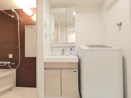 a small bathroom with a sink and a refrigerator at LANG - Vacation STAY 21197v in Tokyo