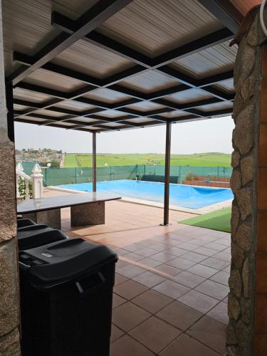 a trash can on a patio with a swimming pool at Villa los Cantos in Toledo