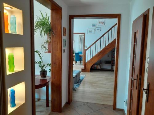 a hallway with a door open to a living room at Ferienhaus in Kolberg mit Grill und Garten in Kołobrzeg