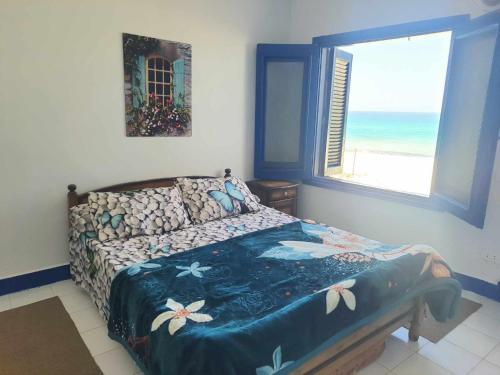 Rúm í herbergi á Hotel appartment sea view 3 bedrooms 3 toilets 3rd floor Bellevue village agami alexandria families are preferred available all year days & 5 blankets available