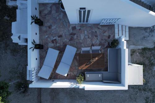 an overhead view of a patio with chairs and a stone wall at DP Homes Santorini in Perissa