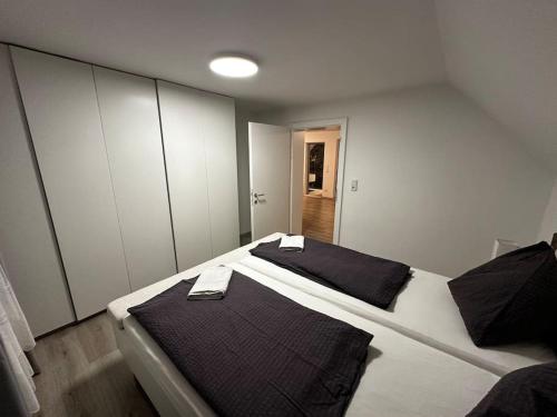 a bedroom with two beds with black and white at Labis Room 2“ in Salzburg