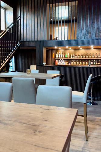 a restaurant with a table and chairs and a bar at Góry Sowie przystanek DAD HOUSE in Sokolec