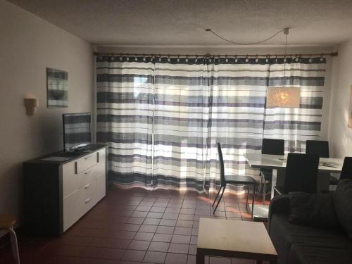 a living room with a couch and a table and a window at Ferienhaus Schlossberg mit kostenloser Nutzung von Bus und Bahn sowie kostenlosem w-lan in Zandt