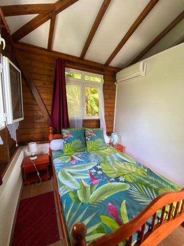 a bedroom with a bed in a room with a window at Maison SOLEIL - VAUCLIN in Le Vauclin
