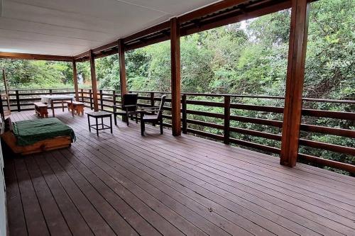 a screened in porch with a table and chairs on it at Serenity, Ponta do Ouro in Ponta do Ouro