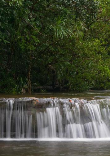 a waterfall in the middle of a river at Thansur Tatai Eco Resort in Tatai
