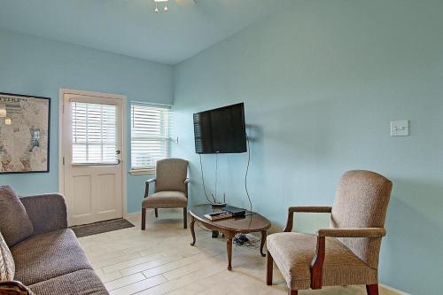 a living room with a couch and chairs and a tv at Captain Quarter's 1 bedrm unit at Sea Isle Village in Port Aransas