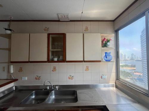 a kitchen with a sink and a large window at Amazing penthouse with stunning views & pool in Cartagena de Indias