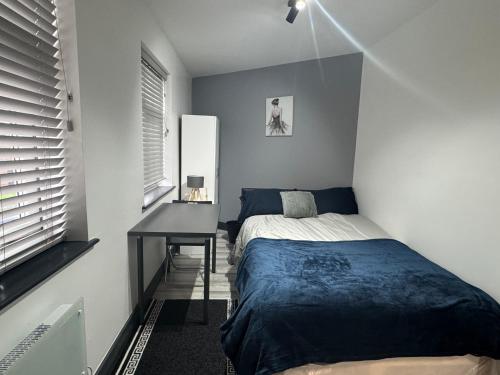 1 dormitorio con cama y escritorio. en P Williams Plumstead, en Plumstead