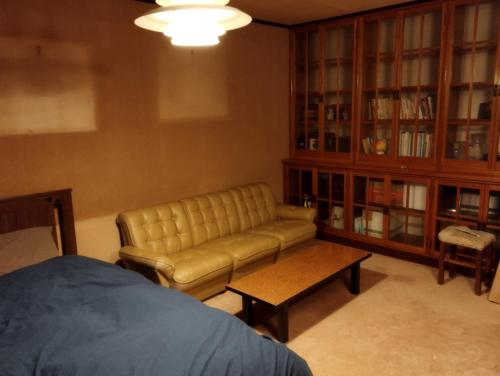 a living room with a couch and a book shelf at Ishinomaki - House - Vacation STAY 16456 in Ishinomaki