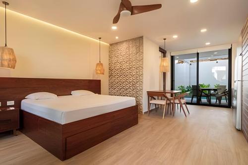 a bedroom with a bed and a dining room with a table at Condo Moots 101 with private pool & rooftop yoga in Tulum