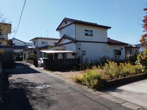 a white house on the side of a street at Ishinomaki - House - Vacation STAY 16456 in Ishinomaki