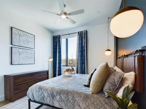 a bedroom with a bed and a ceiling fan at Foxtrot Tango - 2 New Homes - 12 South in Nashville