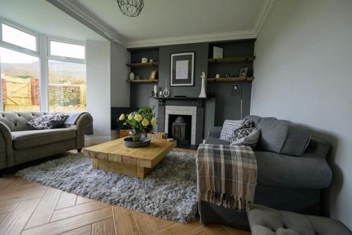 a living room with a couch and a coffee table at Number 2 in Mountain Ash