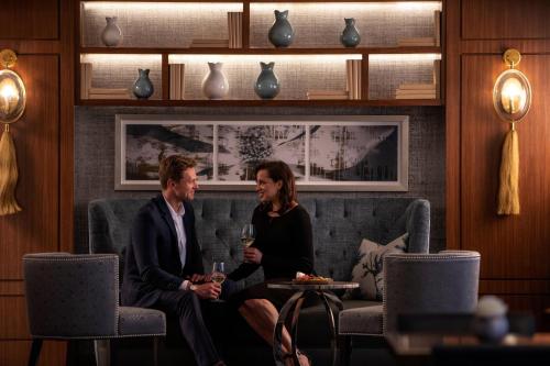 a man and a woman sitting on a couch at The Ritz-Carlton Atlanta in Atlanta
