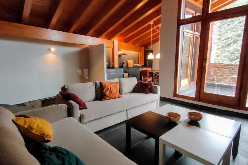 a living room with a couch and a table at Cal cavalé in Vall de Castellbò