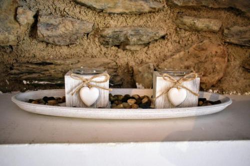 two mason jars with hearts in them on a table at Cal cavalé in Vall de Castellbò