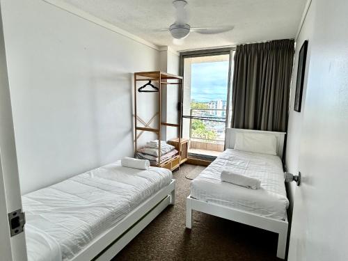 a small room with two beds and a window at Ebbtide, Unit 37 in Forster