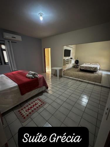 a bedroom with a bed and a tiled floor at Residencial Mirandinha. in Boa Vista