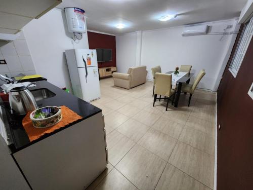 a kitchen and living room with a table and a refrigerator at Departamento “Edificio Manuelita” in Resistencia
