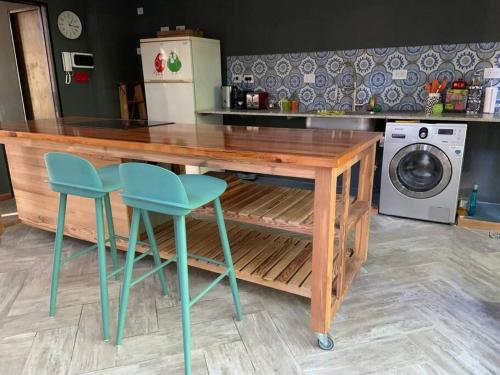 a kitchen with a wooden table and two chairs at Loft moderno en medio del bosque in Arturo SeguÃ­