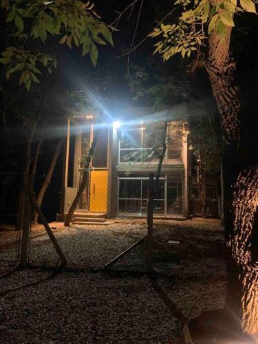 a light in front of a building at night at Loft moderno en medio del bosque in Arturo SeguÃ­