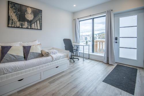 a bedroom with a bed and a desk and a window at Private Unit in the heart of Ottawa, 3 minutes to downtown Ottawa in Ottawa