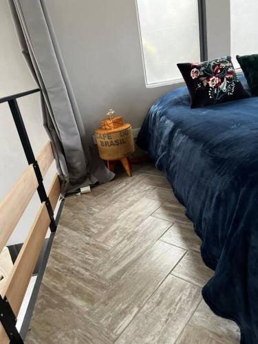 a bedroom with a bed and a wooden floor at Loft moderno en medio del bosque in Arturo SeguÃ­