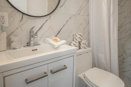 a bathroom with a sink and a toilet and a mirror at Private Unit in the heart of Ottawa, 3 minutes to downtown Ottawa in Ottawa