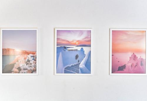 three pictures on a wall in a room at DP Homes Santorini in Perissa