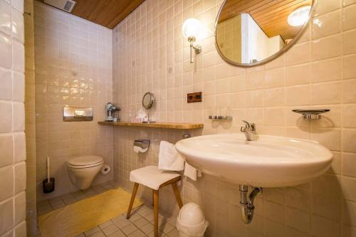 a bathroom with a sink and a toilet at Landhotel Sonnleiten in Bad Reichenhall