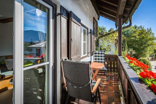 a patio with a table and a chair on a balcony at Landhotel Sonnleiten in Bad Reichenhall