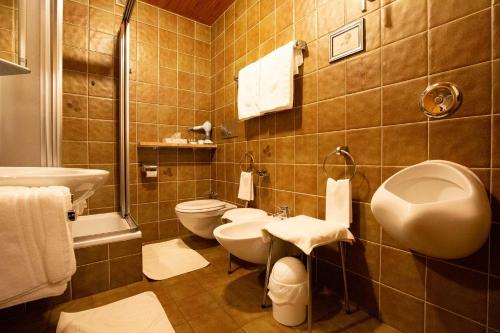 a bathroom with a sink and a toilet at Landhotel Sonnleiten in Bad Reichenhall