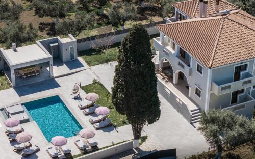an aerial view of a house with a swimming pool at Villa Olympia in Pandokrátor