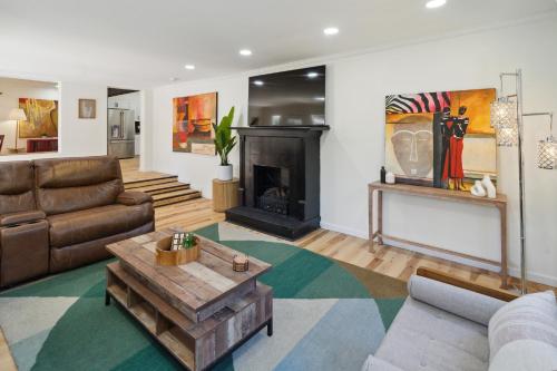 a living room with a couch and a fireplace at Urban Farmhouse with a Modernism Twist! home in Moultrie