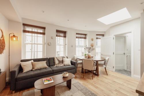 a living room with a couch and a table at Holborn Townhouse in London