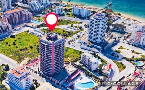 an aerial view of a city with a red marker at Sofiamarholidays - Casa Praia Mar in Portimão