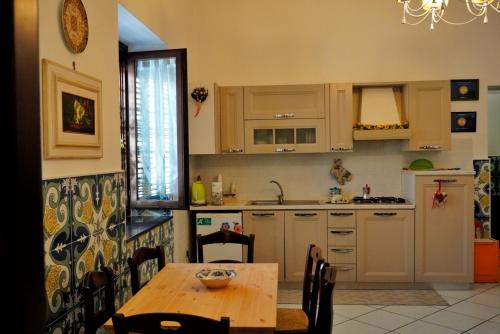 a kitchen with a wooden table and a dining room at Todisco Apartament in Pompei