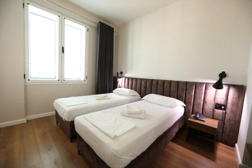 Postel nebo postele na pokoji v ubytování HOTEL LIBERTAS