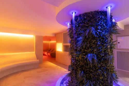 a room with a wall covered in plants at Hotel Mediterraneo in Sottomarina