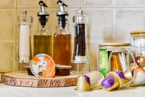 a counter top with a wooden tray with bottles on it at DP Homes Santorini in Perissa