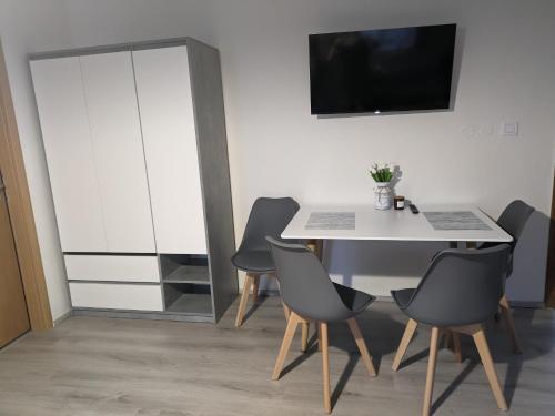 a dining room with a white table and chairs at Penzion Grand Nymburk in Nymburk