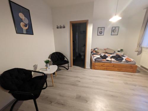 a bedroom with a bed and a table and chairs at Penzion Grand Nymburk in Nymburk