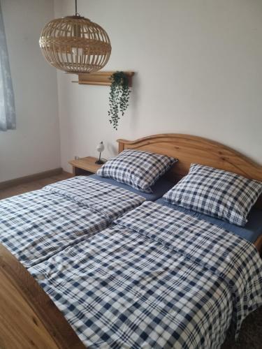 a bedroom with two beds with blue and white sheets at Ferienwohnung im Zenngrund in Neuhof an der Zenn